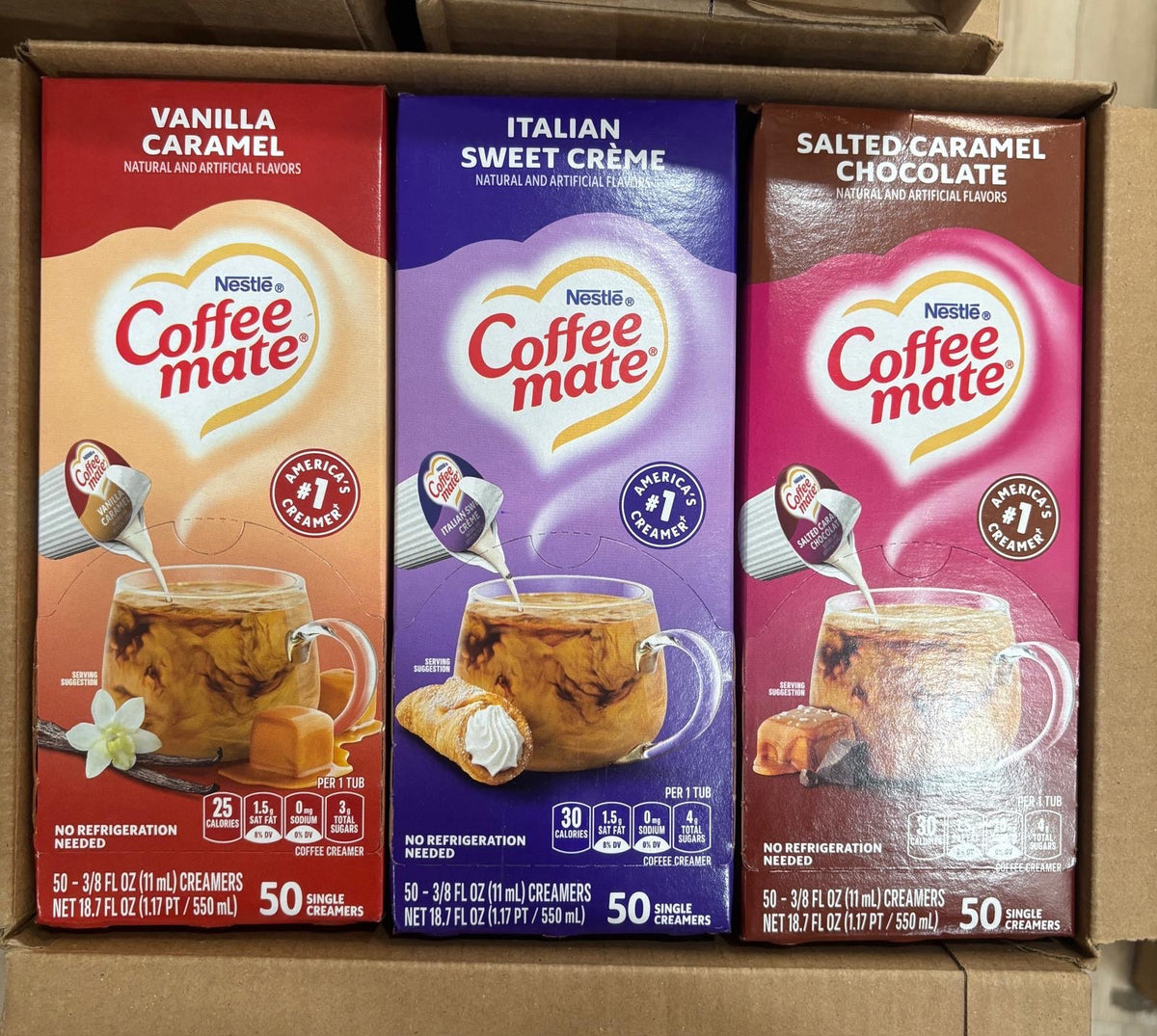 Three Nestle Coffee Mate liquid creamer boxes: Vanilla Caramel, Italian Sweet Creme, Salted Caramel Chocolate