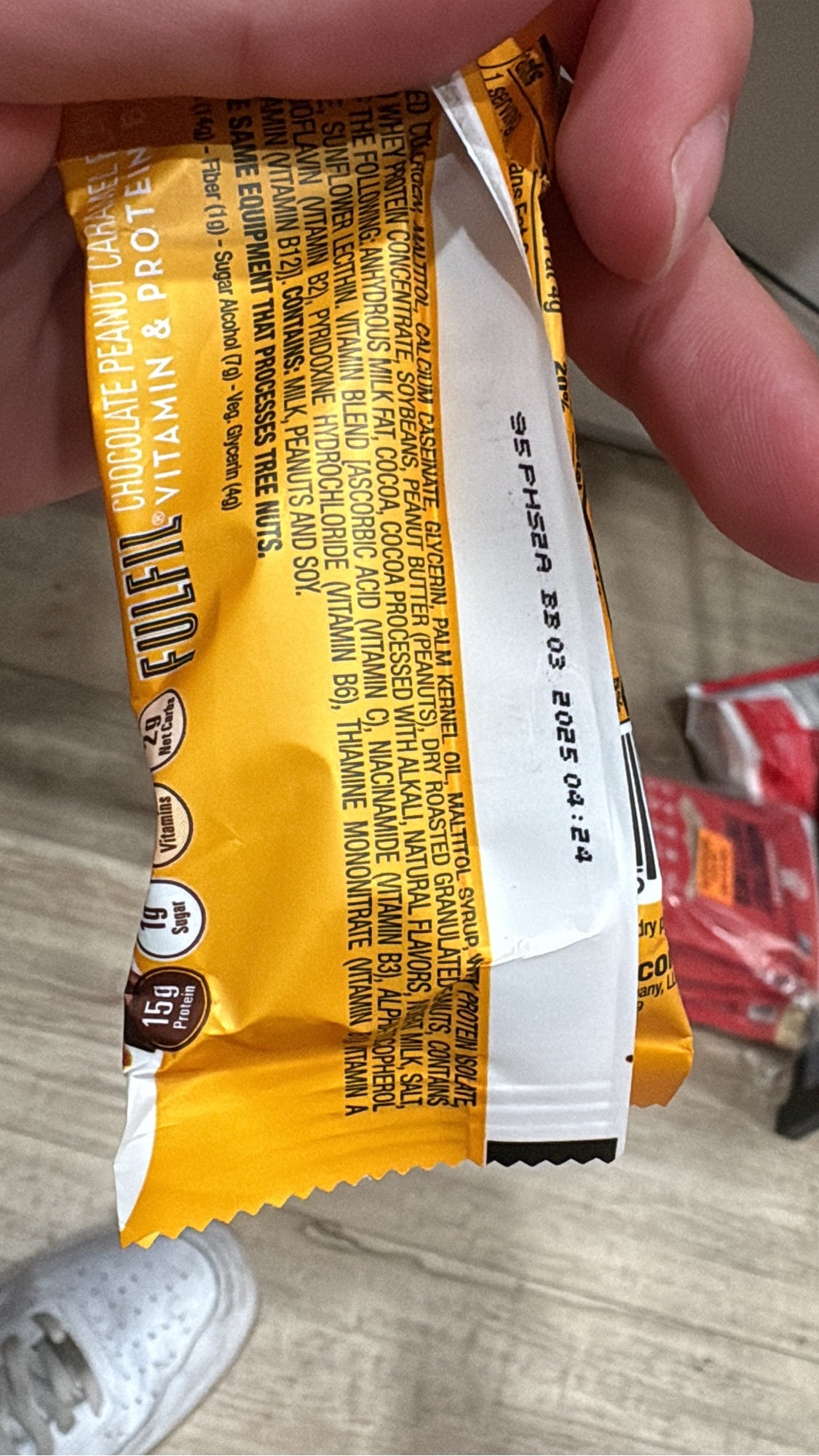 Printed date code BB 03 2025 on a FULFIL Chocolate Peanut Caramel bar