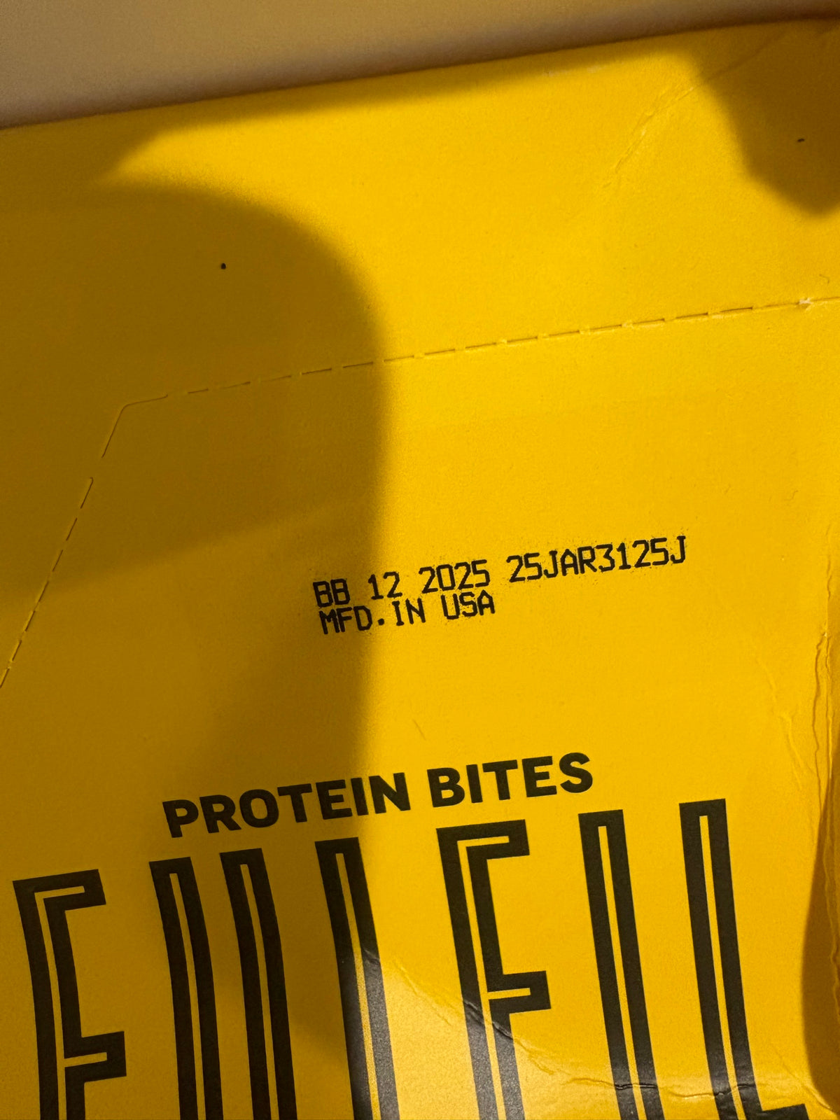 Printed date code BB 12 2025 on the FULFIL Protein Bites case